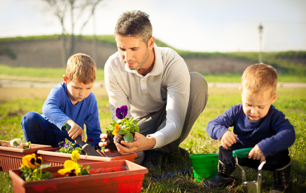 Family planting flowers