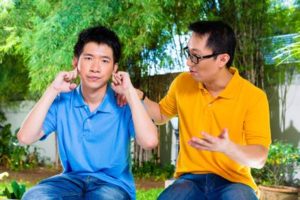 Both/And Parenting.Fotolia.GIFT.Asian dad son.lecture