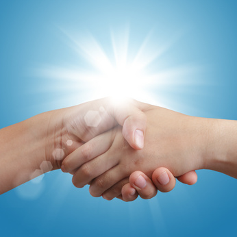 handshake on blue sky and sunlight background