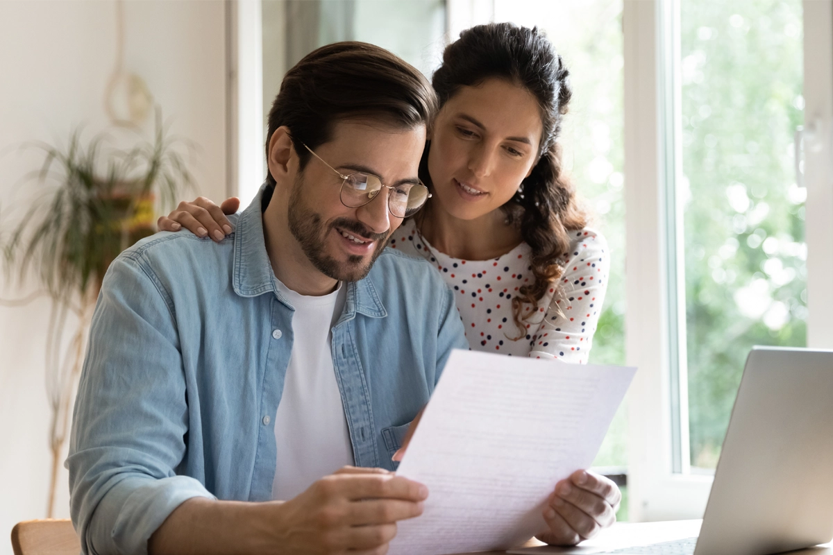 Adopt Main Banner Couple reading a document together at home