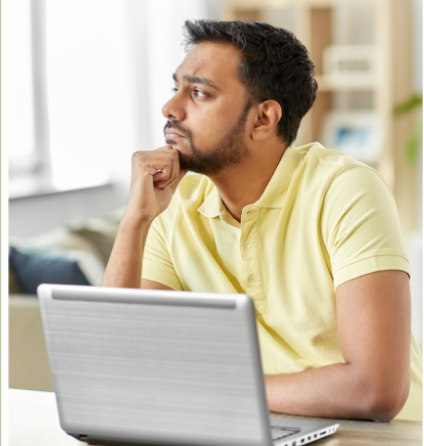 Person thinking at a laptop
